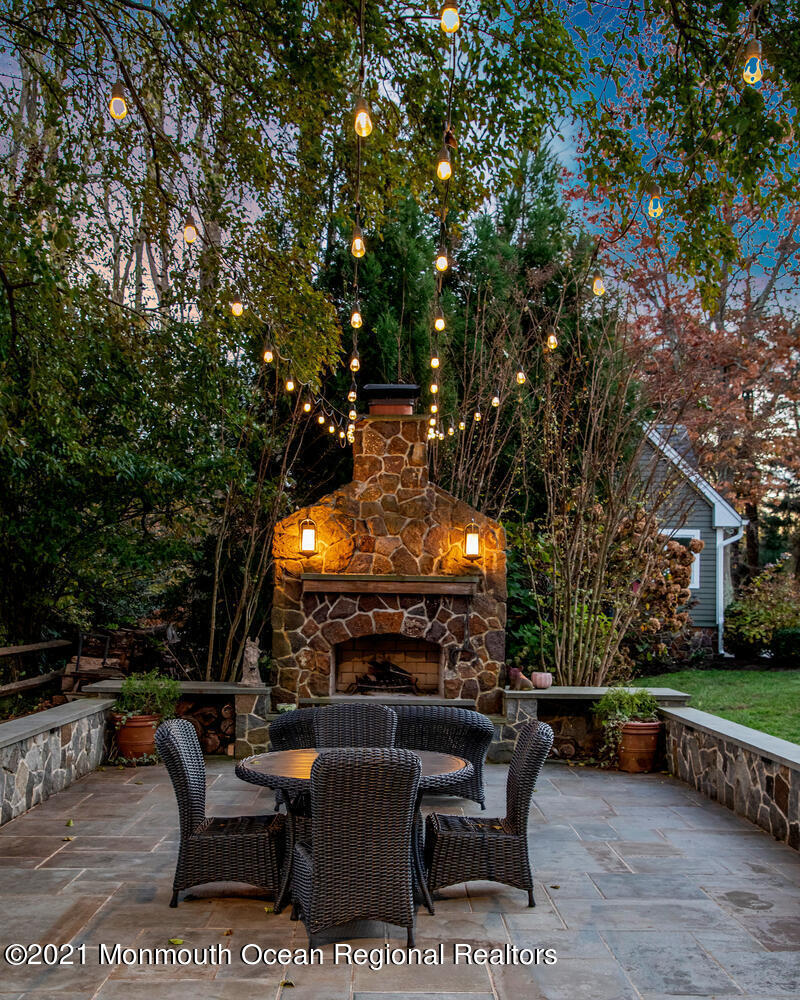 122 Browns Dock Road Middletown, NJ 07716 - Photo 35 of 54 a view of a chairs and tables in the back yard of the house