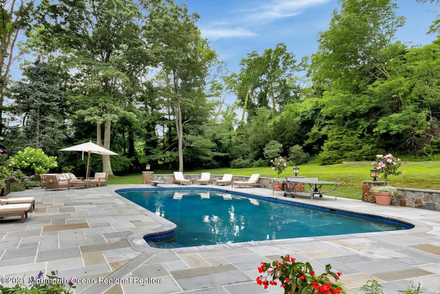 122 Browns Dock Road Middletown, NJ 07716 - Photo 37 of 54 a view of a swimming pool with lawn chairs under an umbrella