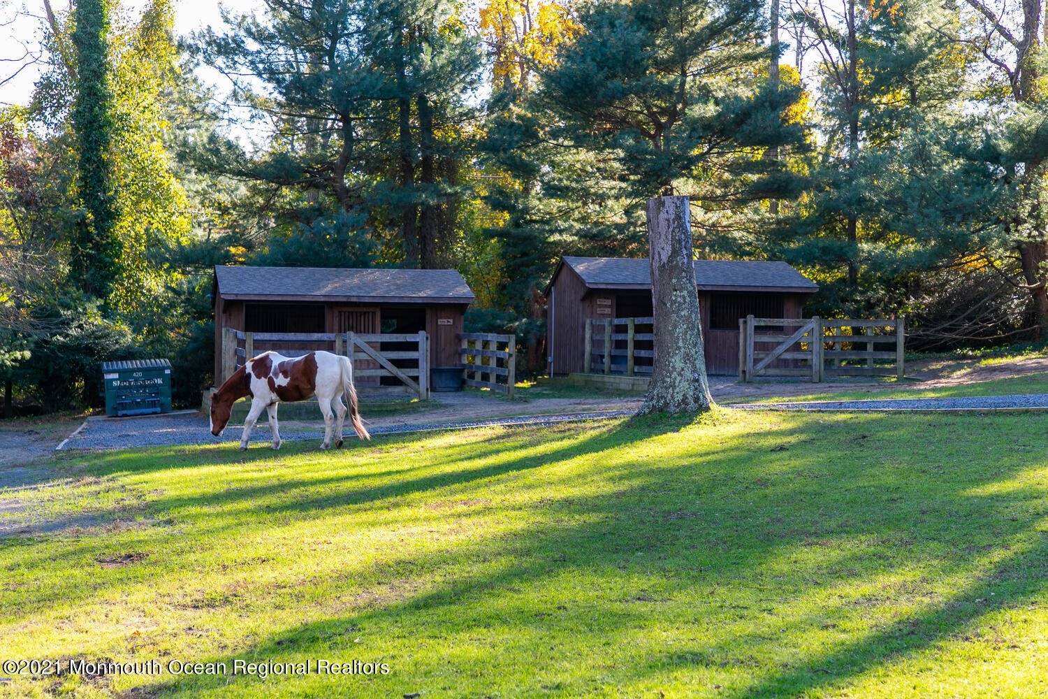 122 Browns Dock Road Middletown, NJ 07716 - Photo 42 of 54 a view of a swimming pool with a table and chairs under an umbrella
