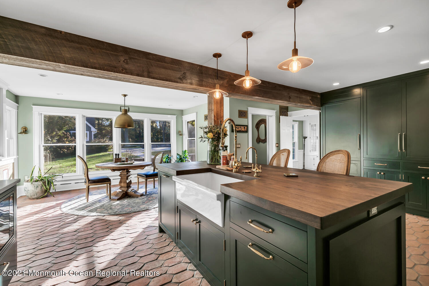 122 Browns Dock Road Middletown, NJ 07716 - Photo 6 of 54 a kitchen with a stove a kitchen island a dining table and chairs with wooden floor