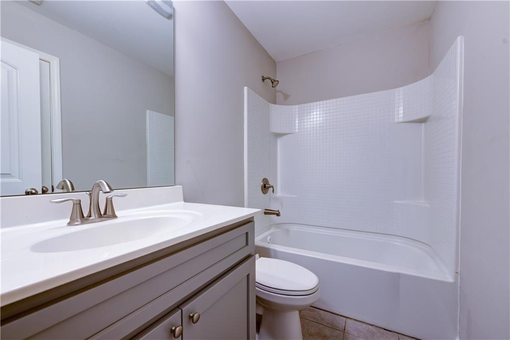 1226 Fischer Trace Cumming, GA 30041 - Photo 21 of 24 a bathroom with a sink a toilet and a bathtub