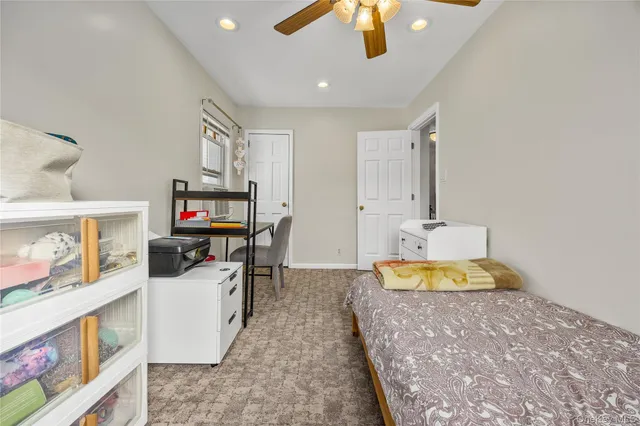 a bed room with a bed and a television