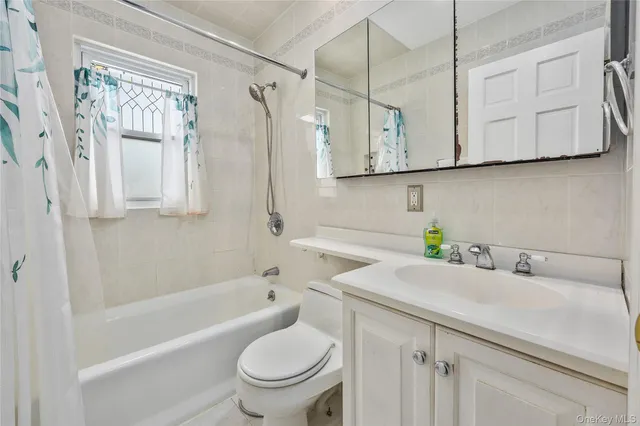 a bathroom with a sink a toilet and bathtub