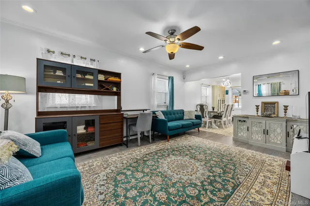a living room with furniture a window and kitchen view