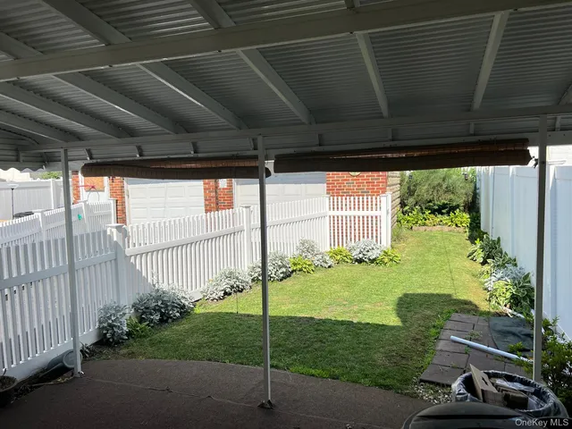 a front view of a house with a yard covered in snow