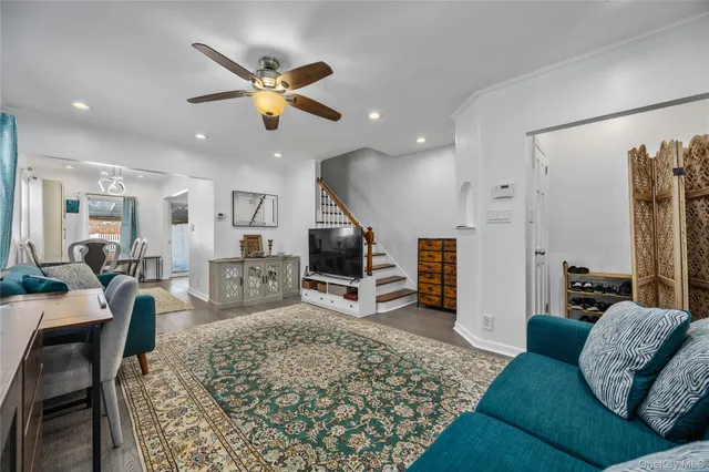 a living room with furniture ceiling fan and a rug