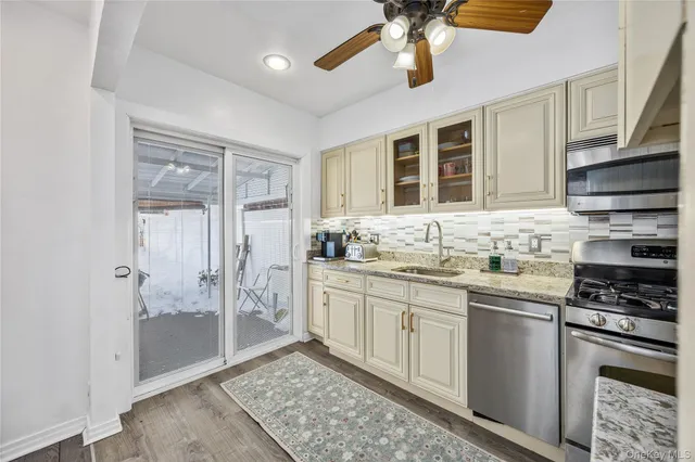 a kitchen with stainless steel appliances granite countertop a stove and cabinets