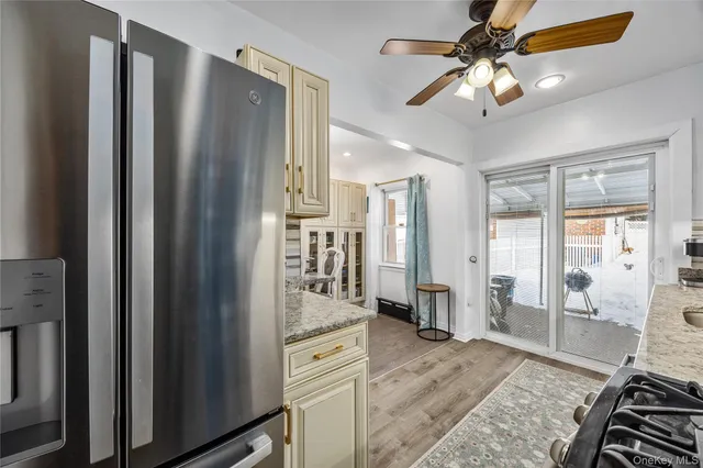 a view of a livingroom with wooden floor and a ceiling fan