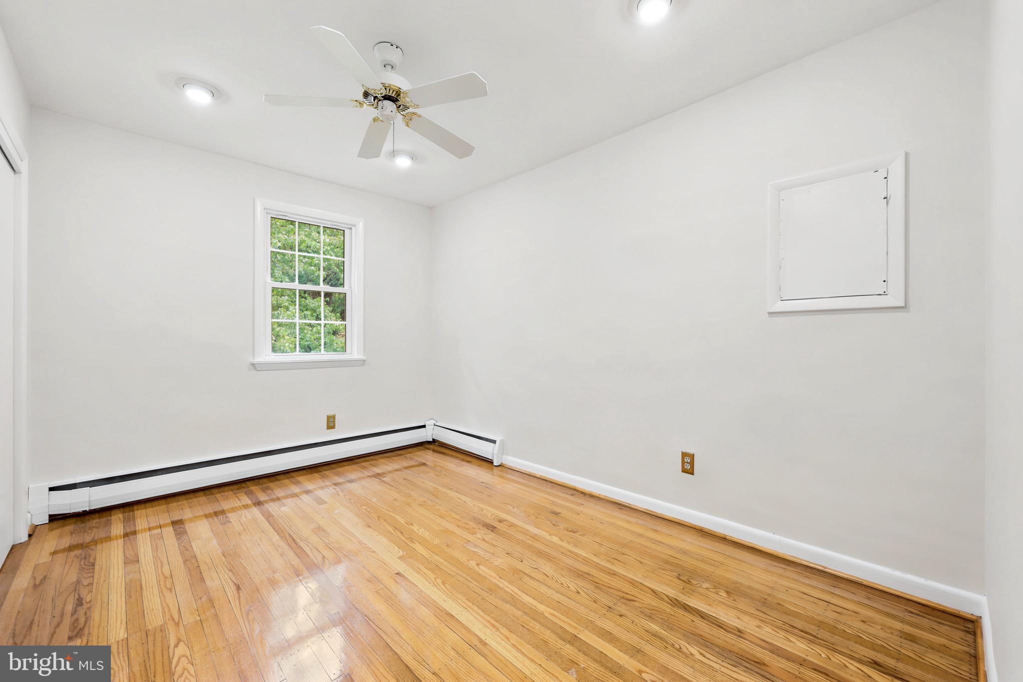 412 Yorkshire Road Bryn Mawr, PA 19010 - Photo 13 of 25 wooden floor in an empty room with a window