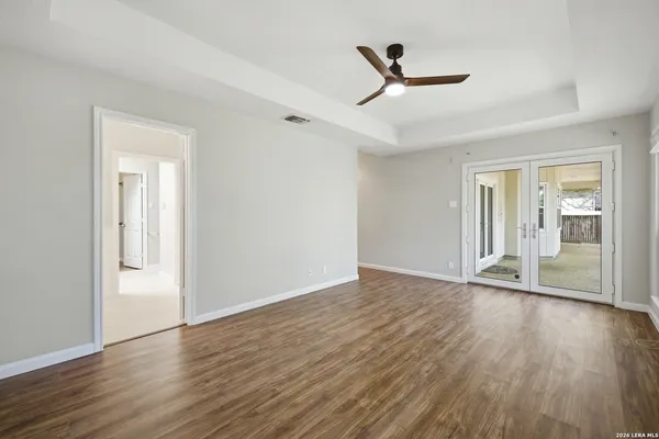 a view of a livingroom with wooden floor and a ceiling fan