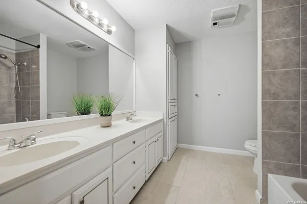 a bathroom with a double vanity sink and mirror