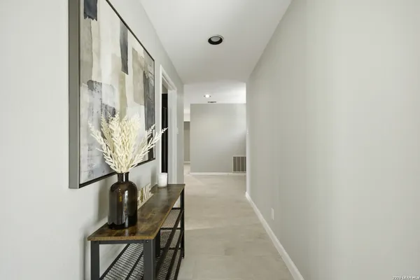 a view of a hallway with wooden floor and entryway