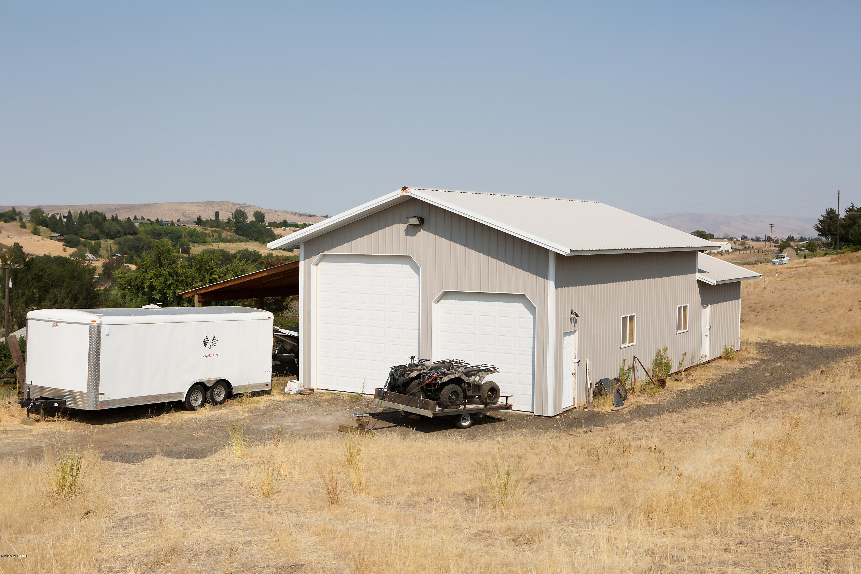 13077 Douglas Road Yakima, WA 98908 - Photo 3 of 35 a view of a white house with a yard