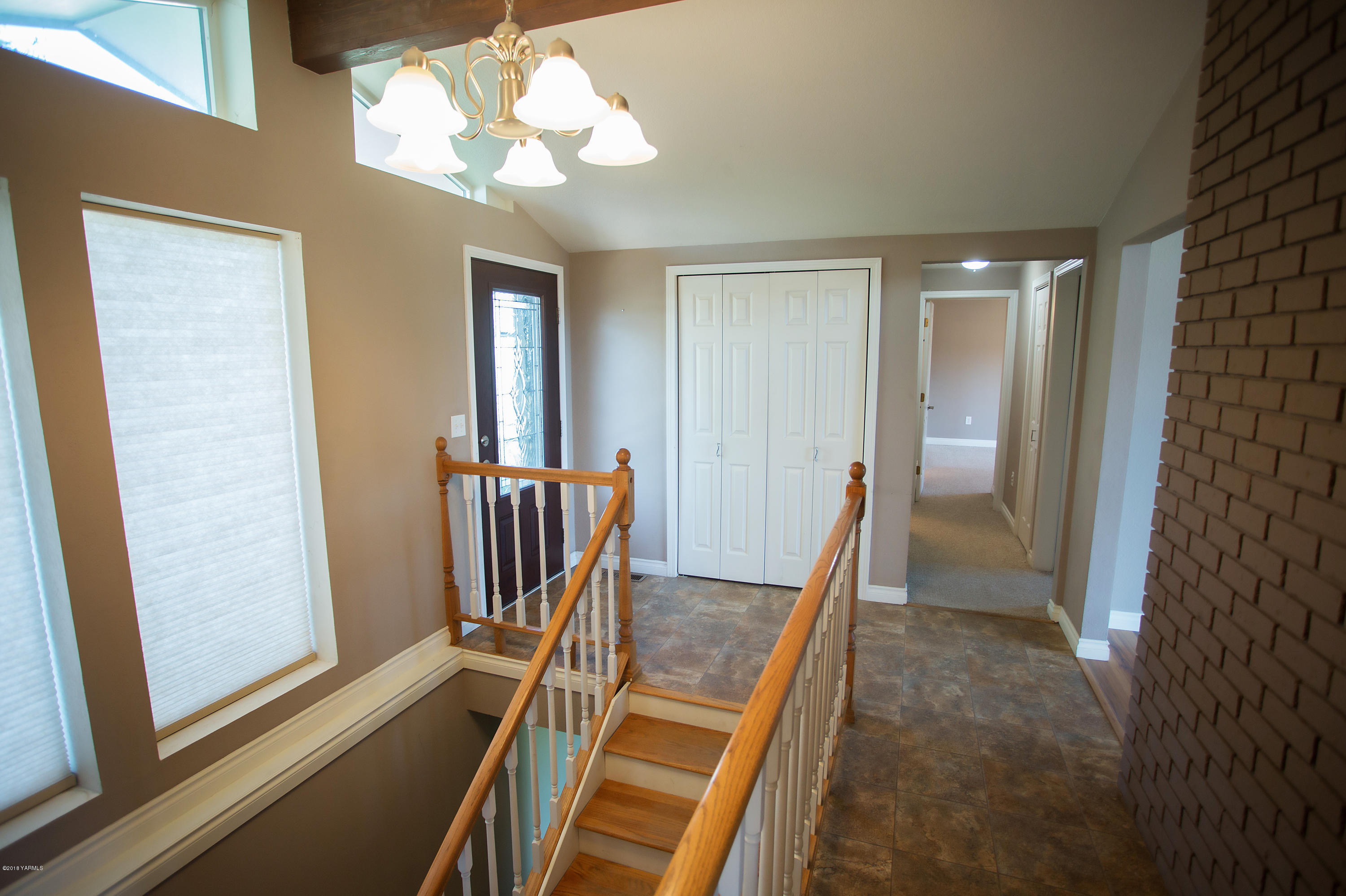 13077 Douglas Road Yakima, WA 98908 - Photo 5 of 35 a view of a hallway with wooden floor and stairs