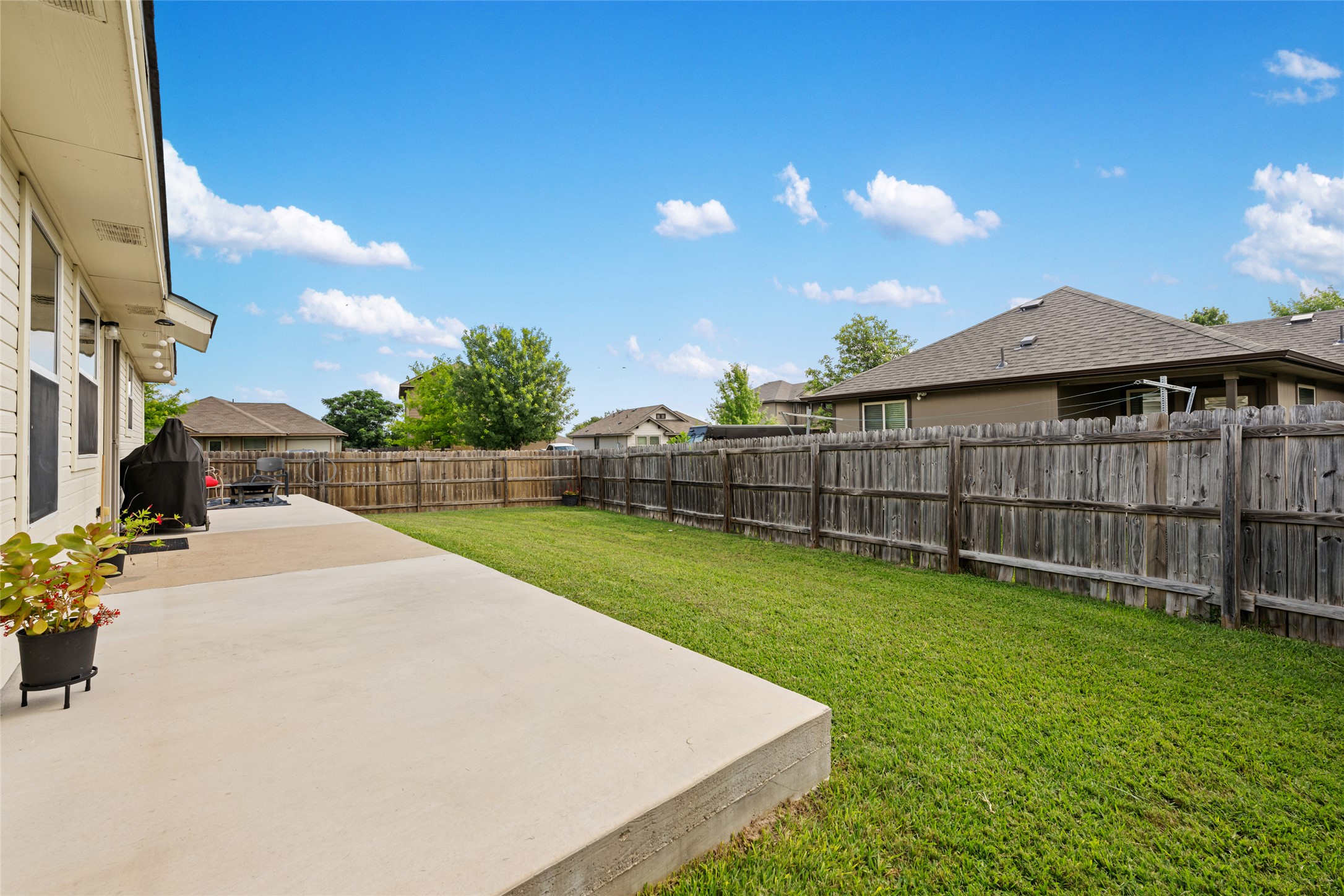 144 Calcite Lane Jarrell, TX 76537 - Photo 36 of 38 A spacious backyard with a generous patio offers ample room for outdoor activities.
