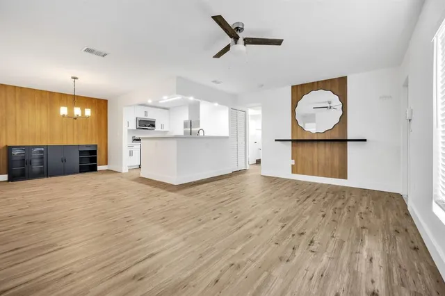 a view of a kitchen with wooden floor and a sink