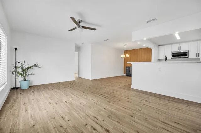 a front view of house with yard and trees in the background