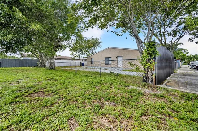 a view of a backyard with large trees