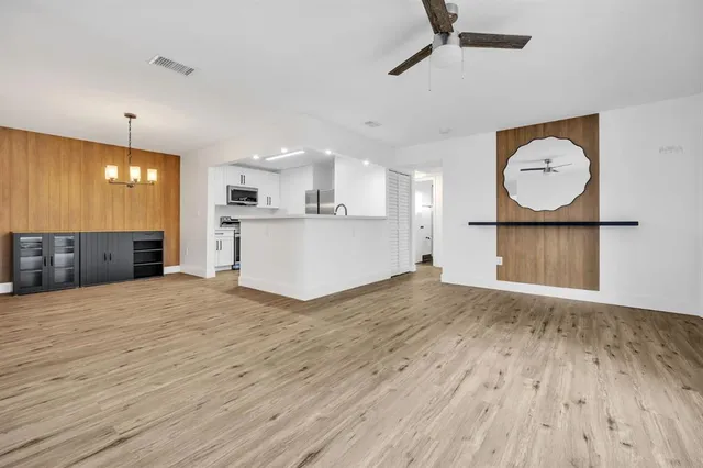 a view of a kitchen with wooden floor and a sink