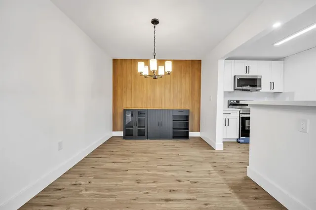 a kitchen with kitchen island a sink stainless steel appliances and window