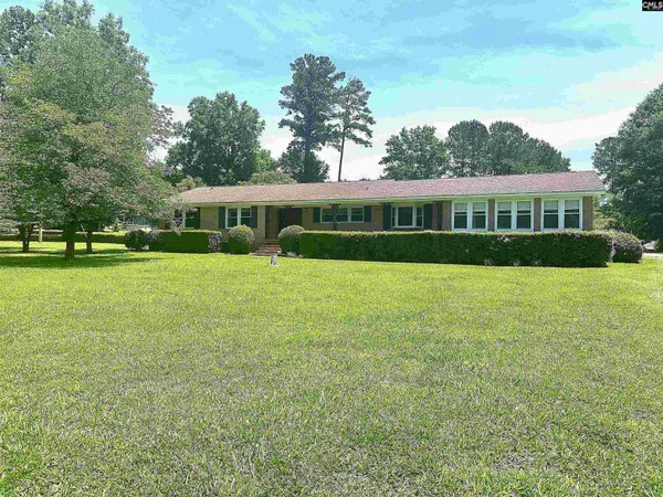 a view of house with yard and green space
