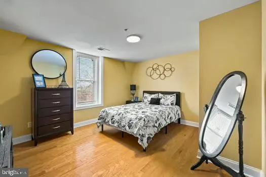 a bedroom with a bed and a mirror