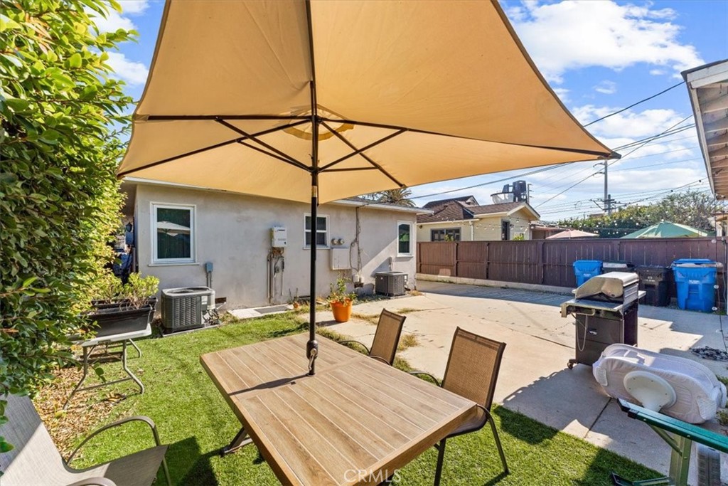 3443 Sherbourne Drive Culver City, CA 90232 - Photo 8 of 21 a view of a patio with table and chairs under an umbrella