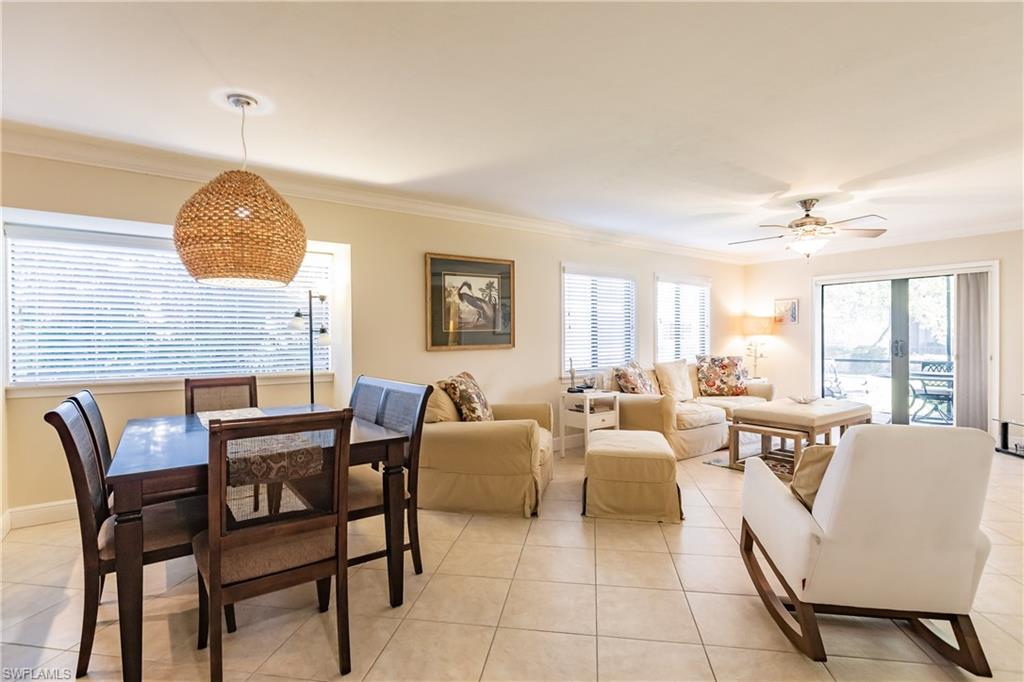 910 Vanderbilt Beach Road, Unit 311W Naples, FL 34108 - Photo 11 of 31 a living room with furniture and a large window