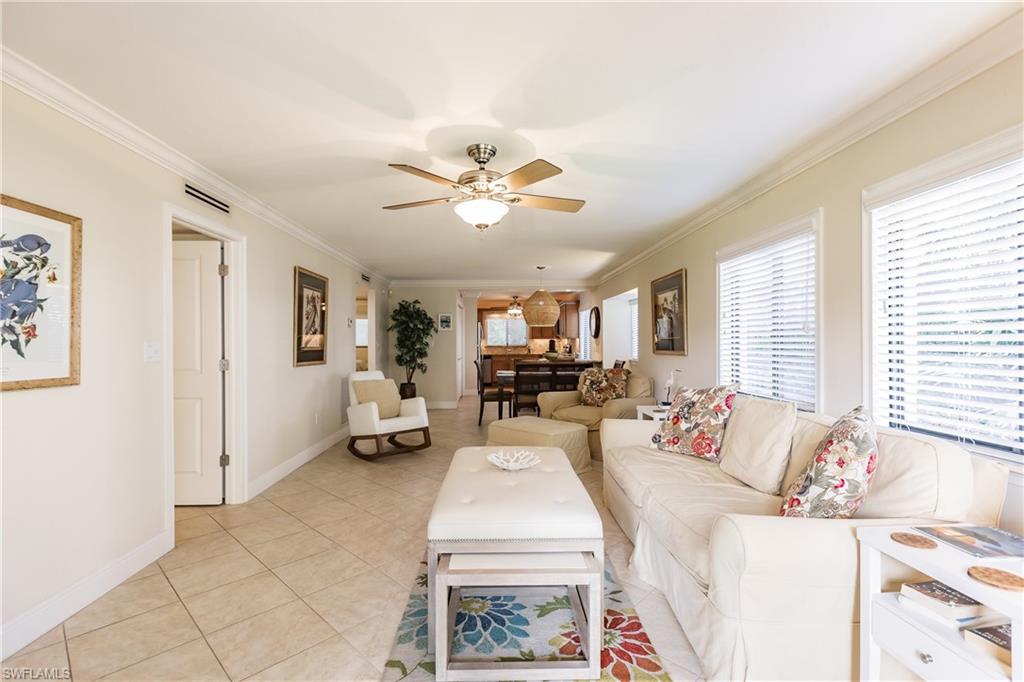 910 Vanderbilt Beach Road, Unit 311W Naples, FL 34108 - Photo 15 of 31 a living room with furniture and a large window