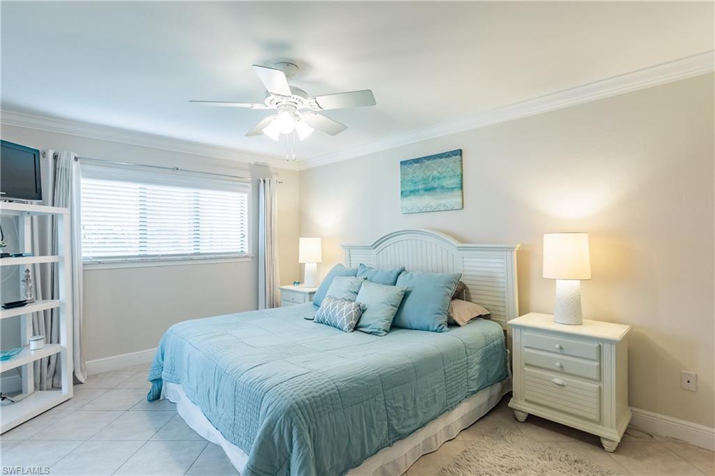 910 Vanderbilt Beach Road, Unit 311W Naples, FL 34108 - Photo 16 of 31 a bedroom with a bed and window