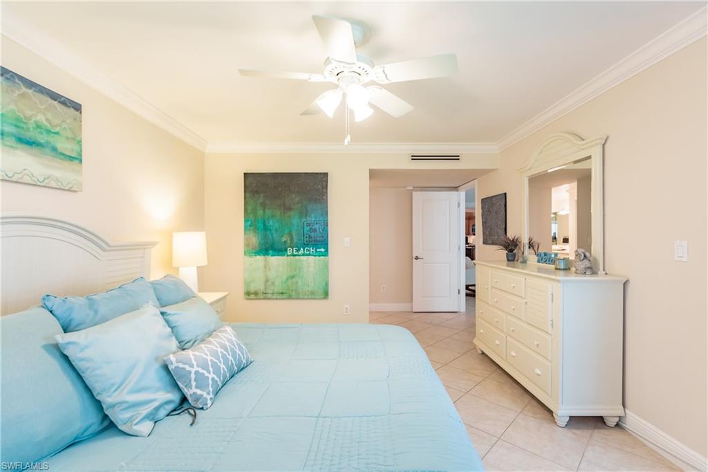910 Vanderbilt Beach Road, Unit 311W Naples, FL 34108 - Photo 19 of 31 a living room with furniture and a large window