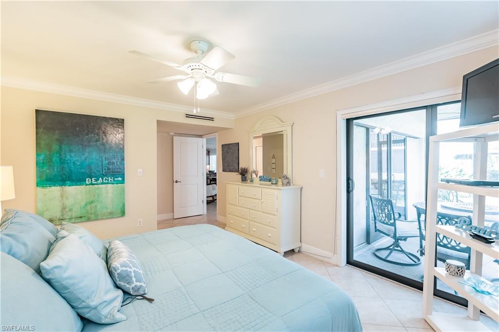 910 Vanderbilt Beach Road, Unit 311W Naples, FL 34108 - Photo 20 of 31 a bedroom with a large bed and a window