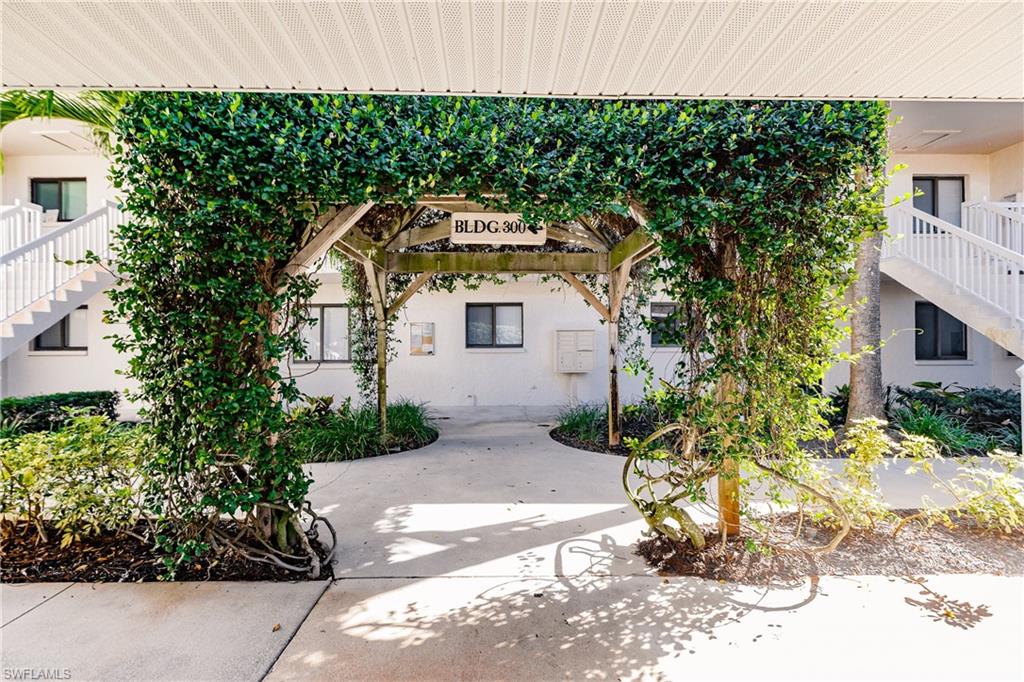 910 Vanderbilt Beach Road, Unit 311W Naples, FL 34108 - Photo 2 of 31 a front view of a house with a yard