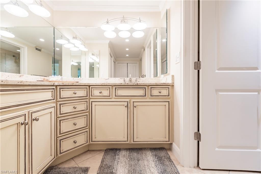 910 Vanderbilt Beach Road, Unit 311W Naples, FL 34108 - Photo 22 of 31 a view of a kitchen with granite countertop cabinets and a sink