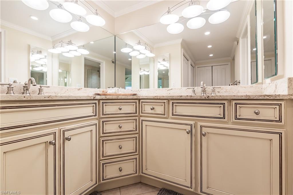 910 Vanderbilt Beach Road, Unit 311W Naples, FL 34108 - Photo 23 of 31 a view of white cabinets and sink
