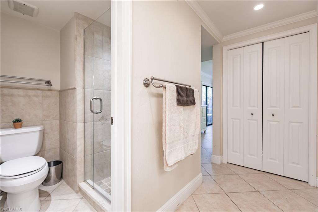 910 Vanderbilt Beach Road, Unit 311W Naples, FL 34108 - Photo 24 of 31 a bathroom with a toilet and a shower