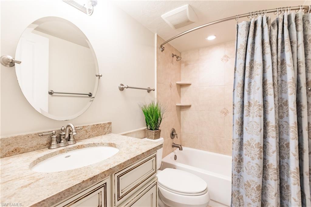 910 Vanderbilt Beach Road, Unit 311W Naples, FL 34108 - Photo 28 of 31 a bathroom with a granite countertop sink toilet and shower