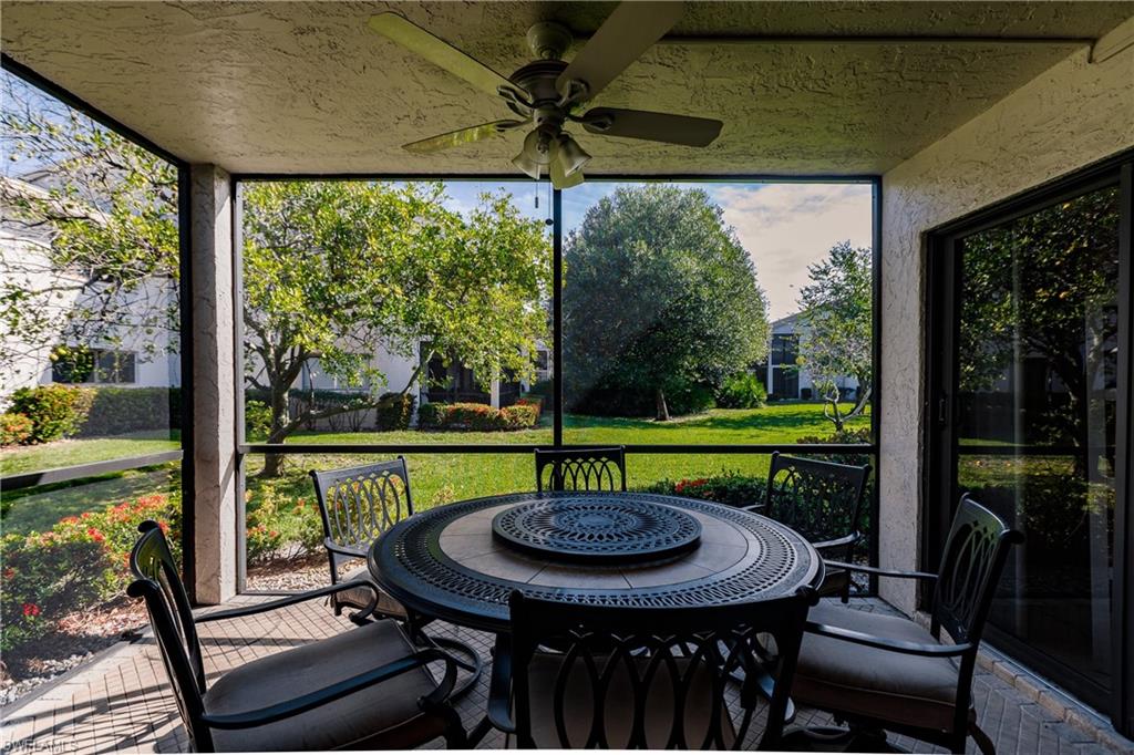 910 Vanderbilt Beach Road, Unit 311W Naples, FL 34108 - Photo 30 of 31 a view of a patio with a table chairs and a table