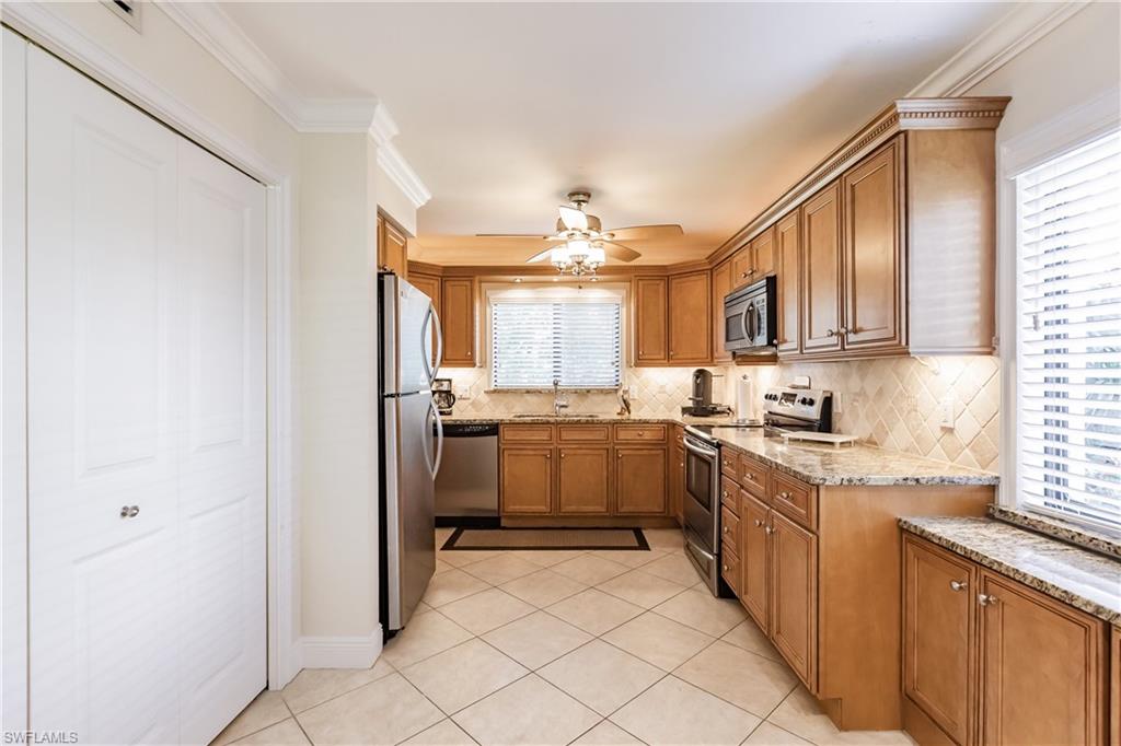 910 Vanderbilt Beach Road, Unit 311W Naples, FL 34108 - Photo 4 of 31 a kitchen with sink cabinets and window