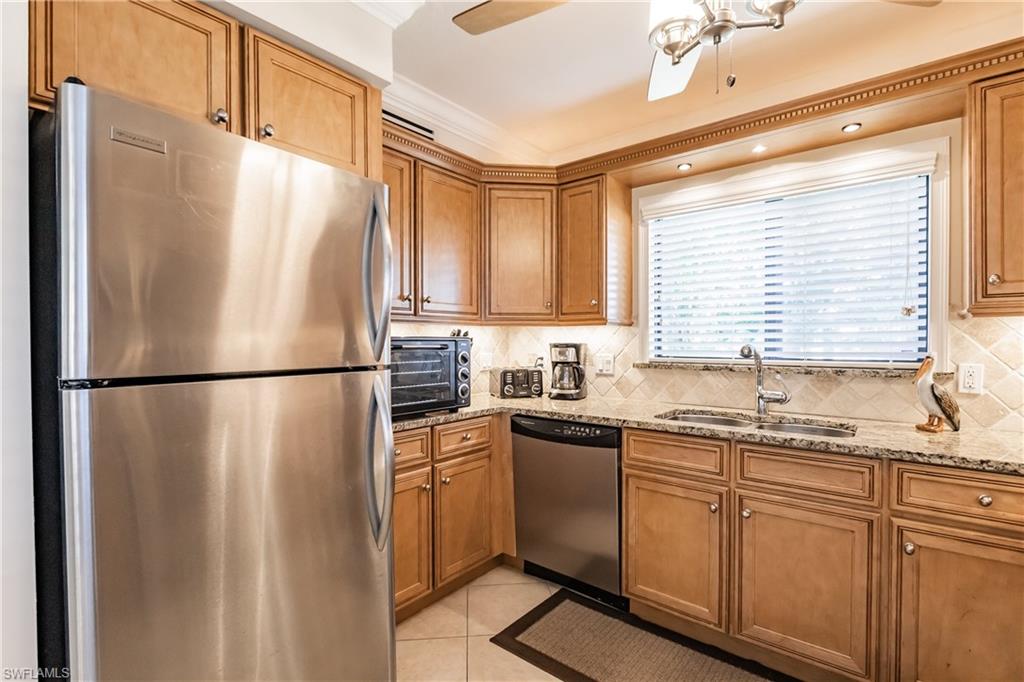 910 Vanderbilt Beach Road, Unit 311W Naples, FL 34108 - Photo 7 of 31 a kitchen with appliances a sink and a window