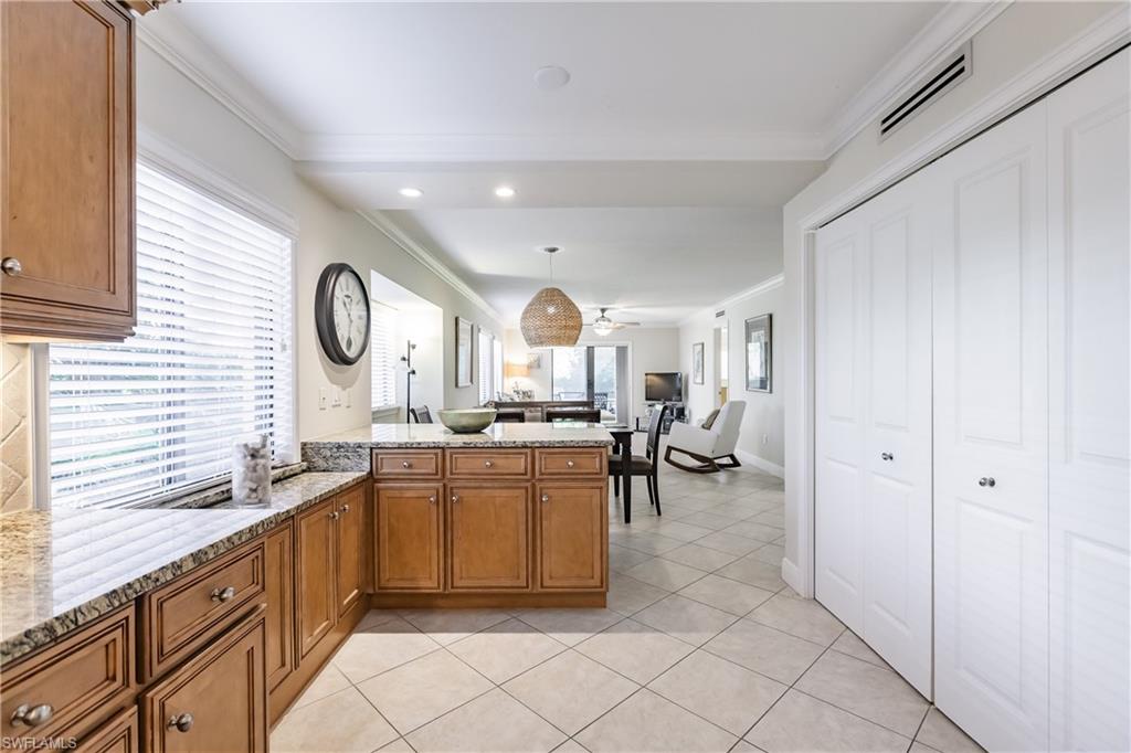 910 Vanderbilt Beach Road, Unit 311W Naples, FL 34108 - Photo 8 of 31 a large white kitchen with a large window