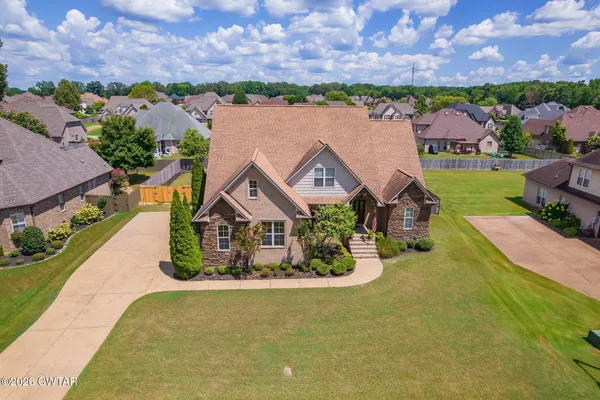 an aerial view of a house with a swimming pool yard and outdoor seating