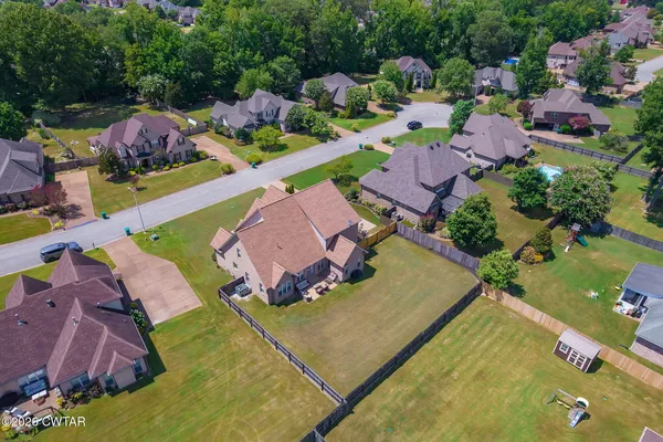 a view of a house with a backyard and a tree