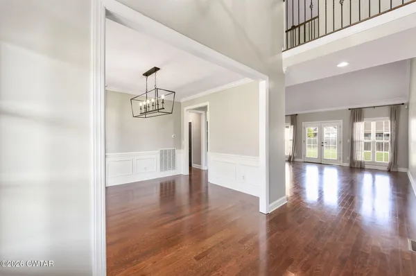 a view of a hallway with wooden floor