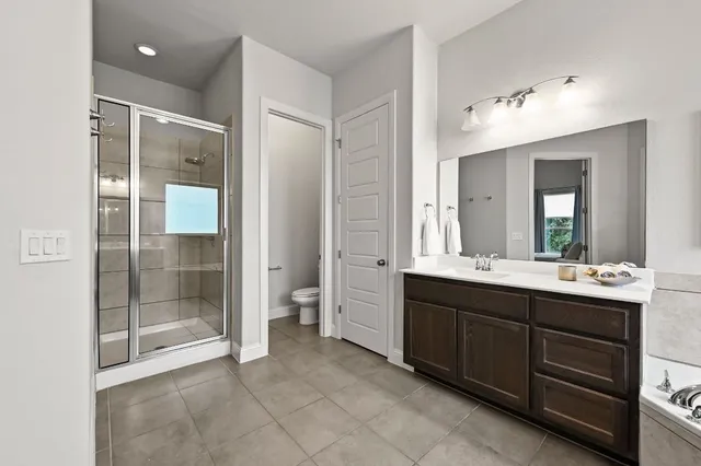 a spacious bathroom with a double vanity sink mirror and double