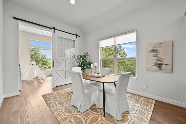 a view of a dining room with furniture window and wooden floor