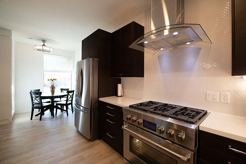 3029 Bering Drive Houston, TX 77057 - Photo 10 of 12 a kitchen with a stove and wooden floor