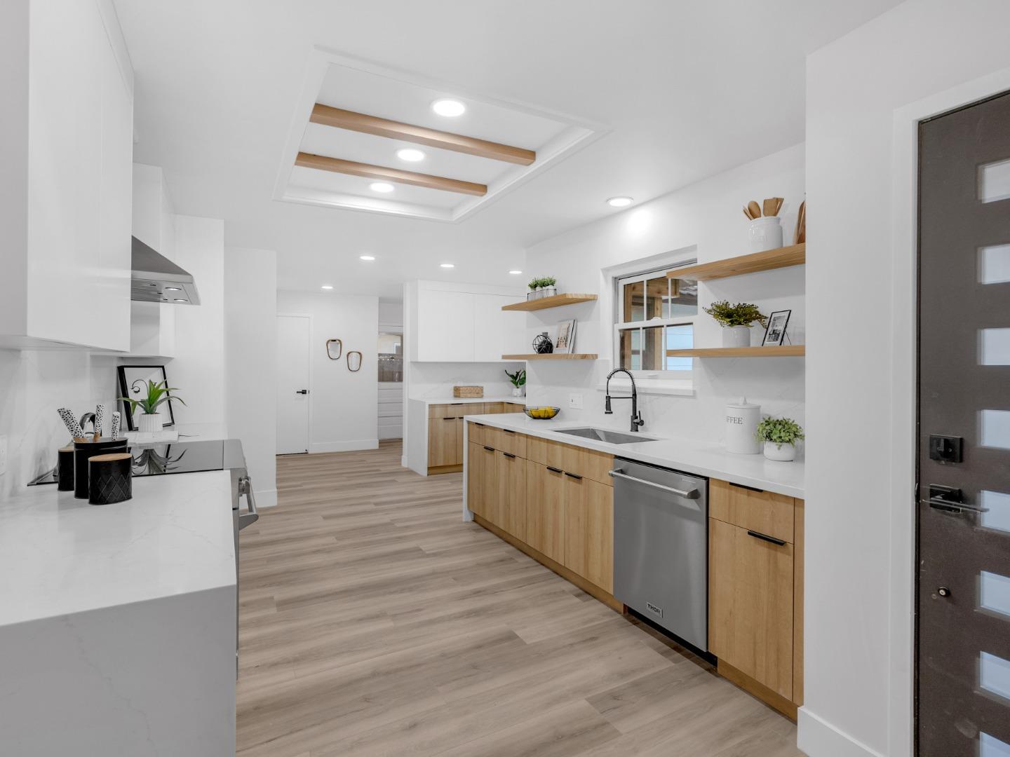 2303 Gunar Drive San Jose, CA 95124 - Photo 11 of 42 a large kitchen with a lot of counter space and wooden floor