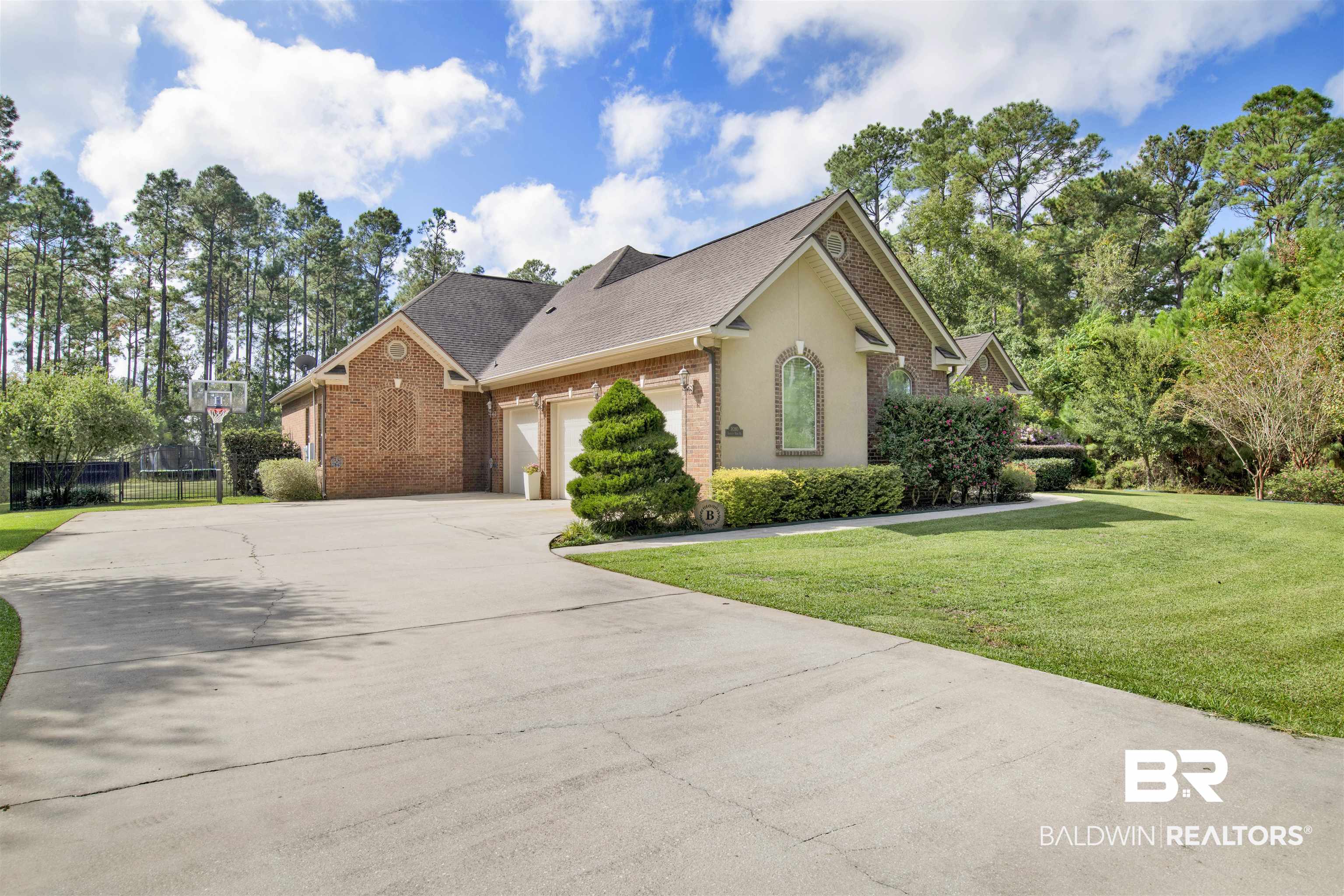 18360 Treasure Oaks Road Gulf Shores, AL 36542 - Photo 55 of 57 View of front property featuring a garage and a front yard