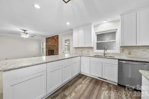 a kitchen with granite countertop cabinets stainless steel appliances a sink and a counter top space